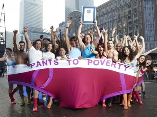 Pants to Poverty founder (holding up the certificate) along with 59 other people who crammed into one pair of pants for Guinness World Records Day in 2011.