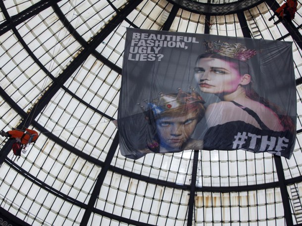Greenpeace activist climbs the cupola of the Galeria Vittorio Emanuele to demand toxic-free fashion. Photo via Greenpeace.