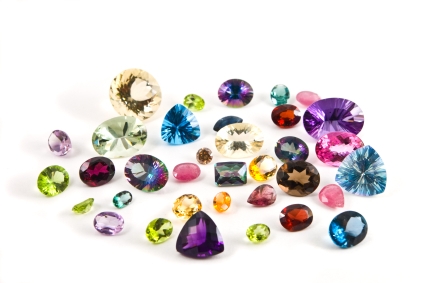 A grouping of different faceted gemstones. Photo via VIJI.